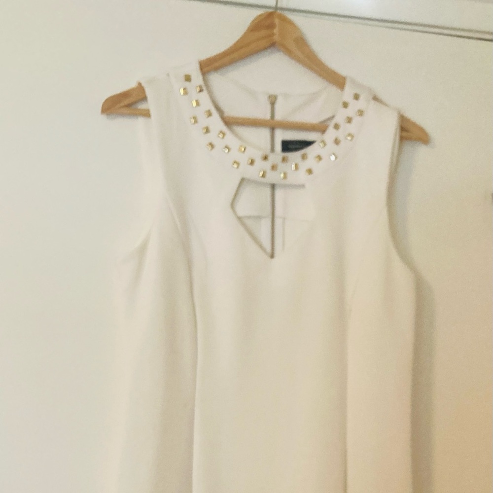 Cream color body con dress. With Gold stud accent.